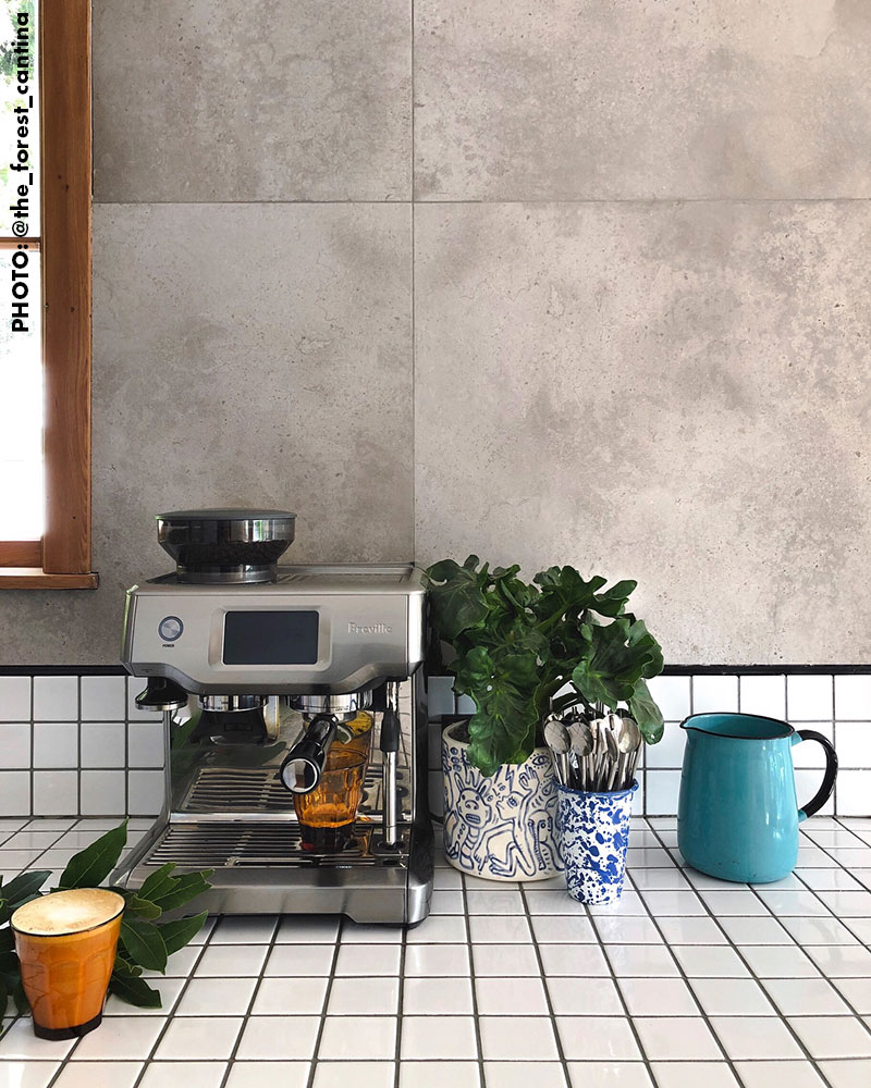dark grey stone and white tiles in a kitchen with a coffee machine