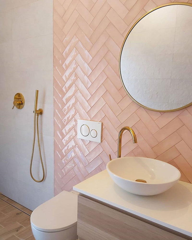 rose gold (pink) tiles in a bathroom splashback with modern shower, sink and mirror